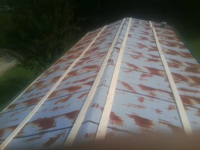 Rusted metal roof panels with new wood purlins before replacement — Storm Damage Roof Repair in Yorktown Heights by Roofing Brothers