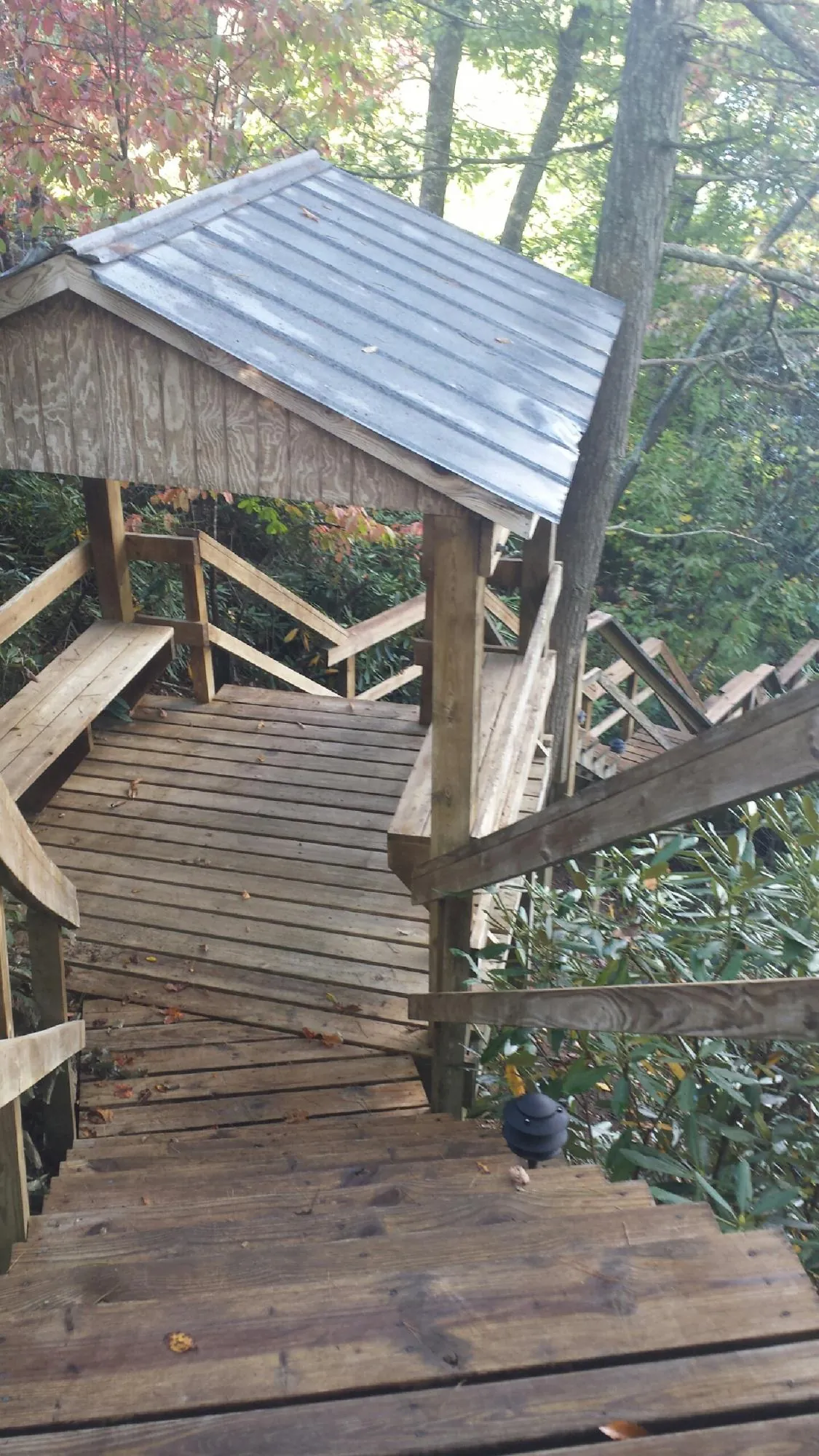 Metal roofed shelter over wooden steps on a wooded walkway — Skylight Repair & Installation work by our crew in Yorktown Heights